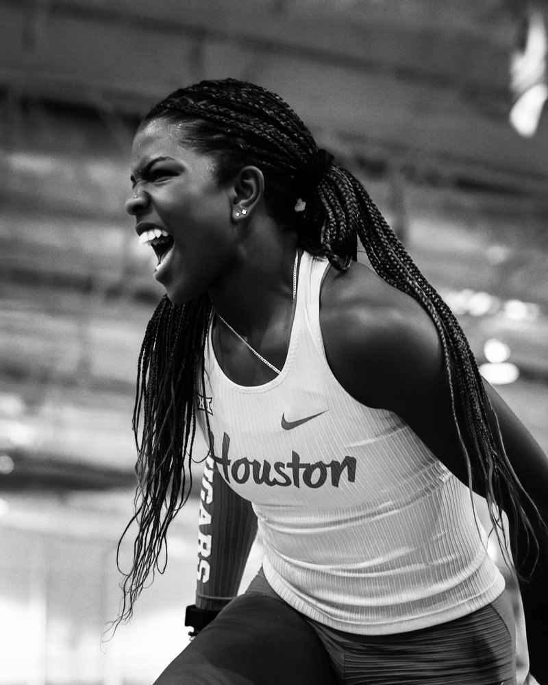 Black-and-white portrait of Jaiya Devi Daniels in a University of Houston track jersey